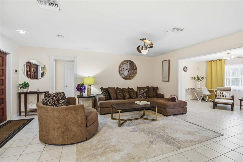 A living room features a brown sectional, a round armchair, and a coffee table — 3136 BISPHAM ROAD, SARASOTA, FL