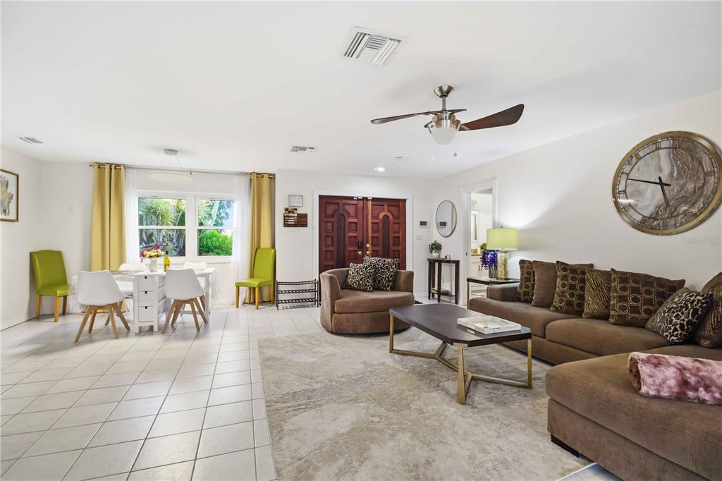 A living and dining area features tile floors, a brown sectional, and a ceiling fan — 3136 BISPHAM ROAD, SARASOTA, FL