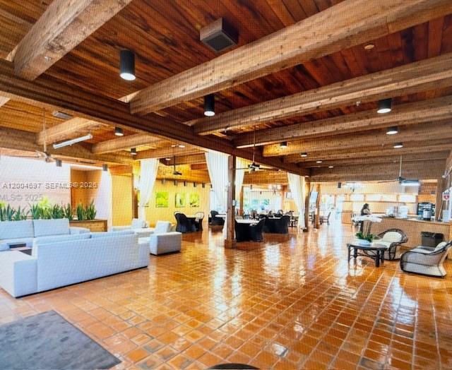 A spacious room features a wood-beamed ceiling, terracotta tile flooring, and multiple seating areas — 4000 Towerside Ter # 1403, Miami FL 33138, MIAMI, FL