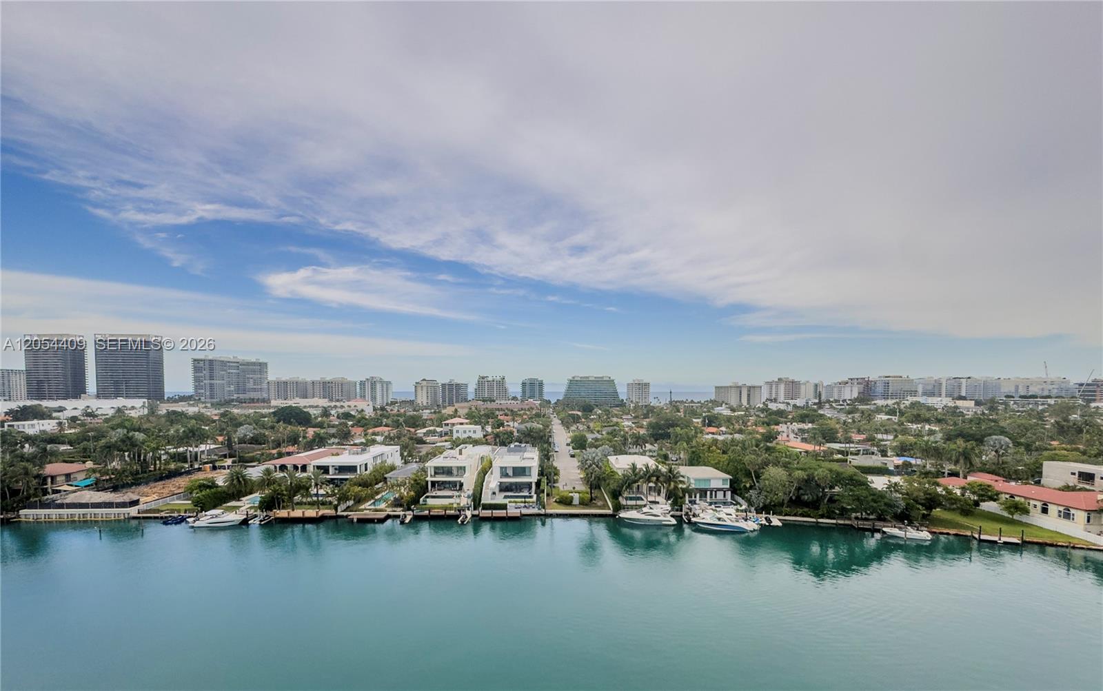 An aerial view shows a waterfront neighborhood with luxury homes, private docks, and yachts — 9261 E Bay Harbor Dr # 405, Bay Harbor Islands FL 33154, BAY HARBOR ISLANDS, FL