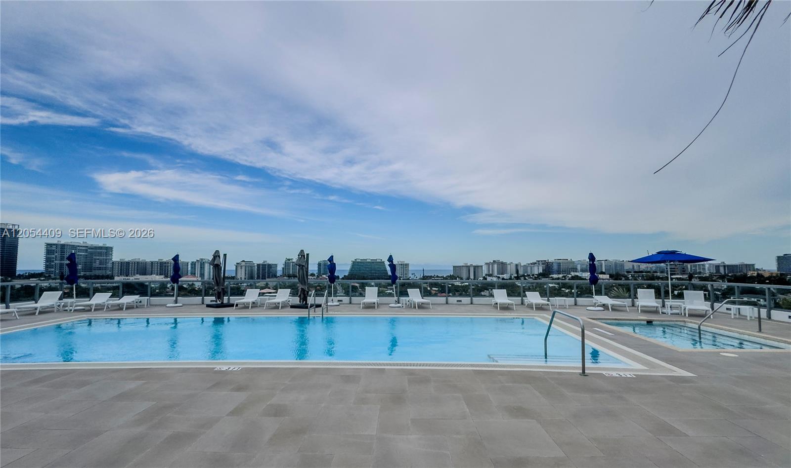 A rooftop swimming pool and hot tub overlook a city skyline under a cloudy sky — 9261 E Bay Harbor Dr # 405, Bay Harbor Islands FL 33154, BAY HARBOR ISLANDS, FL