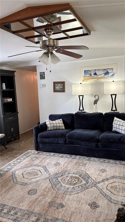 A living room features a dark blue sofa, a patterned rug, and a ceiling fan — 8456 SW STATE ROAD 47, LAKE CITY, FL