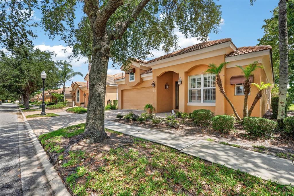 A single-story stucco house with a tile roof, a two-car garage, and a paved driveway — 10 LAKESIDE WAY, PALM COAST, FL