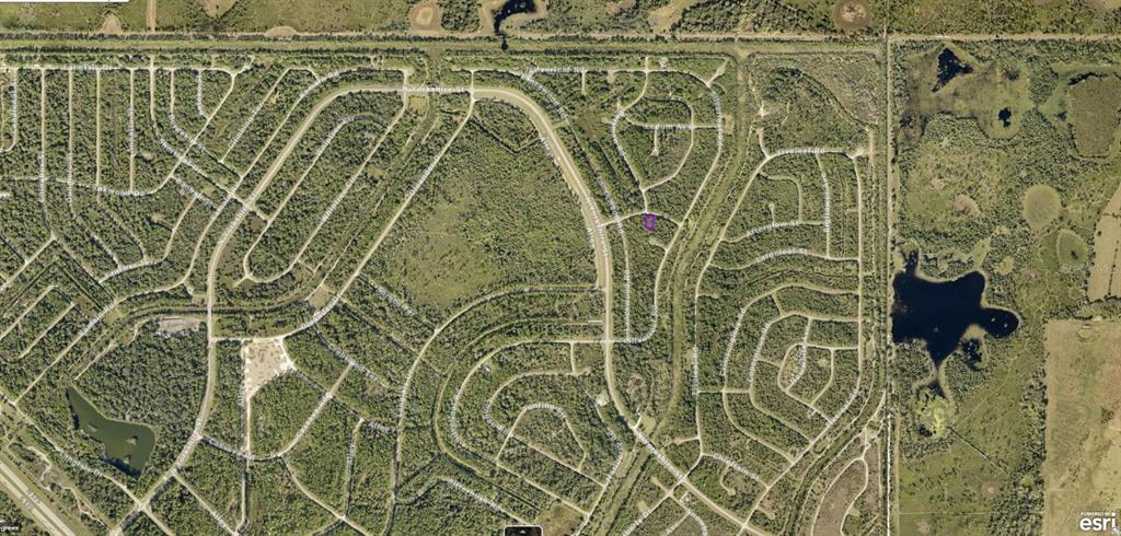 This is an aerial map view of a residential neighborhood with a highlighted vacant lot — 1127227518 SPIRAL LANE, NORTH PORT, FL