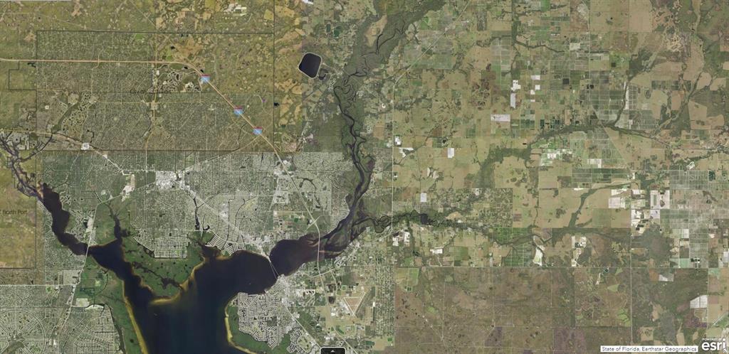 This is an aerial map view of a river flowing through a residential area — 1127227518 SPIRAL LANE, NORTH PORT, FL