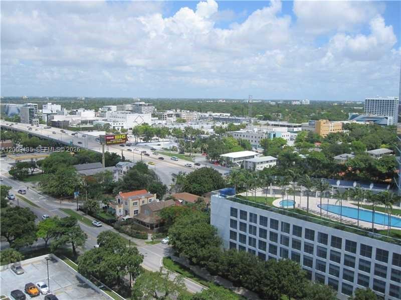 An elevated view of a city street, highway, and a building with a swimming pool — 600 NE 36th St # 1109, Miami FL 33137, MIAMI, FL