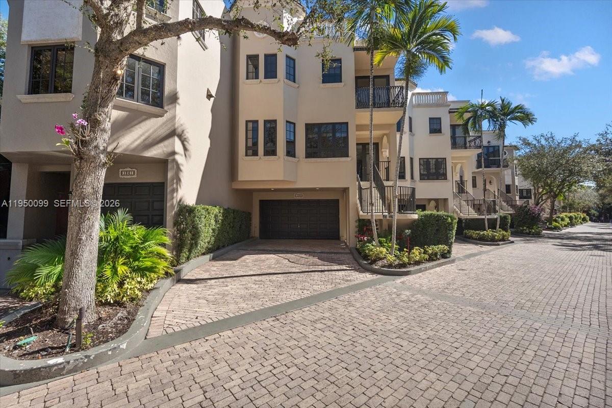 A multi-story townhouse exterior features a paved driveway, a garage, and balconies — 3471 Main Hwy # 1240, Miami FL 33133, MIAMI, FL