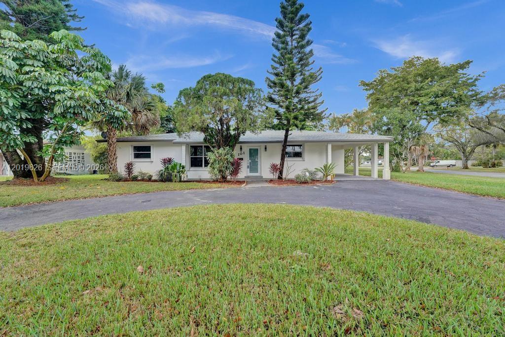 A single-story house with a white facade, a carport, and a circular asphalt driveway — 101 SW 53rd Ave, Plantation FL 33317, PLANTATION, FL