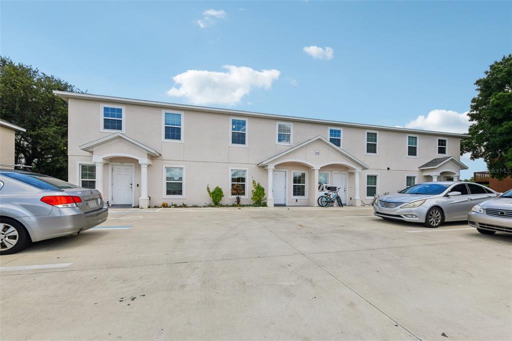A two-story apartment building with a concrete parking lot in front — 210 MAJORS LANE UNIT B, KISSIMMEE, FL