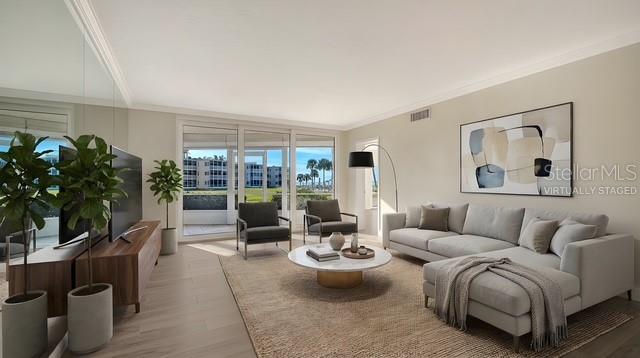 A living room features a sectional sofa, two armchairs, a coffee table, and large windows — 4835 GULF OF MEXICO DRIVE UNIT 106, LONGBOAT KEY, FL