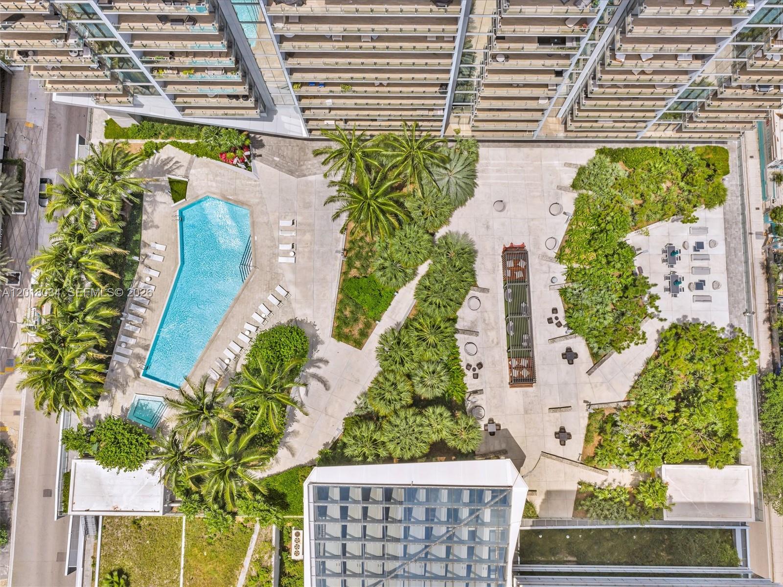 An aerial view shows a swimming pool, landscaped gardens, and a patio area with seating — 88 SW 7th St, Miami FL 33130, MIAMI, FL