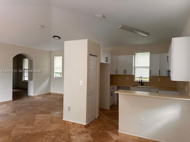 A kitchen with white cabinets and a breakfast bar opens to a tiled living area — 21733 Ingraham Ave Rd # 21733, Cutler Bay FL 33190, CUTLER BAY, FL