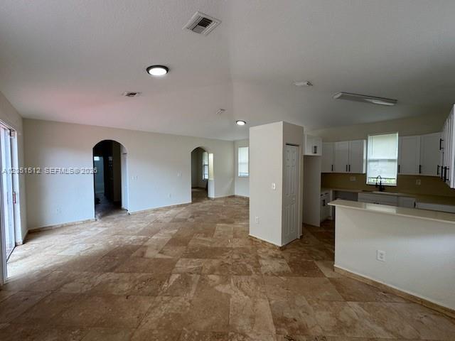An open-concept living area features light-colored walls, tile flooring, and an adjacent kitchen — 21733 Ingraham Ave Rd # 21733, Cutler Bay FL 33190, CUTLER BAY, FL