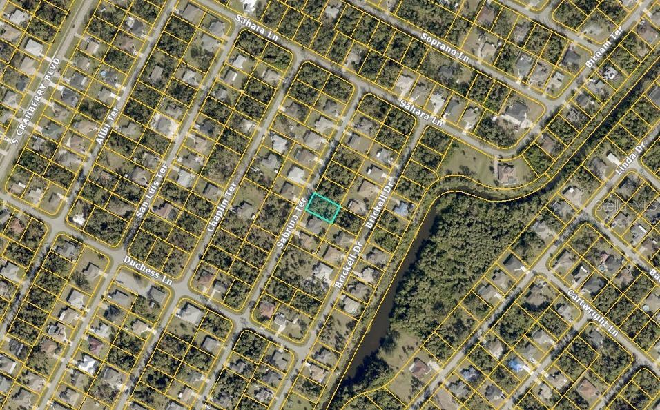 This is an aerial map showing a vacant residential lot highlighted in a suburban neighborhood — SABRINA TERRACE, NORTH PORT, FL
