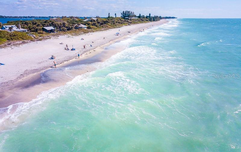 An aerial view of a sandy beach with turquoise water and coastal homes — SABRINA TERRACE, NORTH PORT, FL