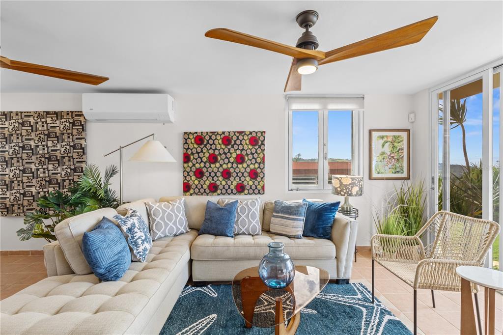 A living room features a beige sectional sofa, a blue patterned rug, and a ceiling fan — Carr. 960 Km. 17.6 BO.GUZMAN ARRIBA, RIO GRANDE, PR