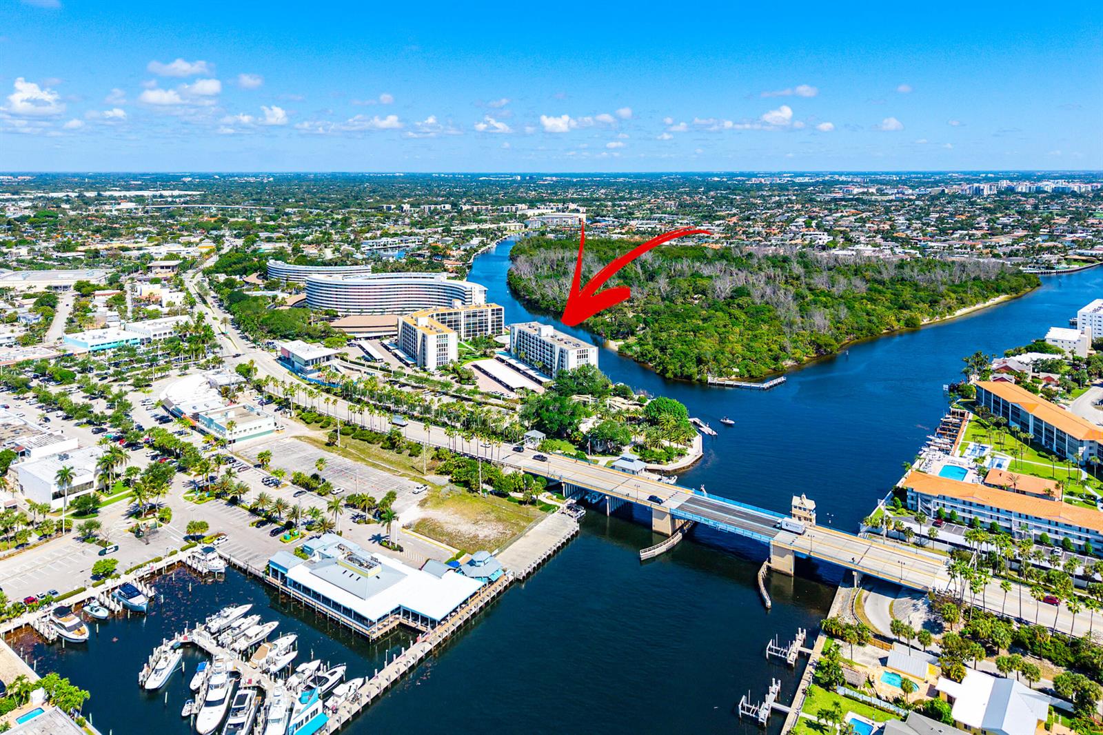 An aerial view shows a waterfront apartment complex near a bridge and a boat marina — 1631 Riverview Road # 505, Deerfield Beach FL 33441, DEERFIELD BEACH, FL