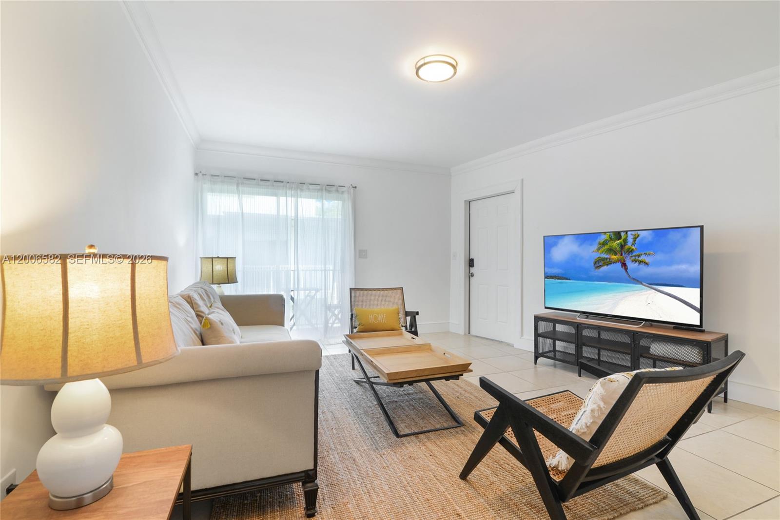 A living room features a sofa, two chairs, a coffee table, and a television — 1142 99th St # 24, Bay Harbor Islands FL 33154, BAY HARBOR ISLANDS, FL