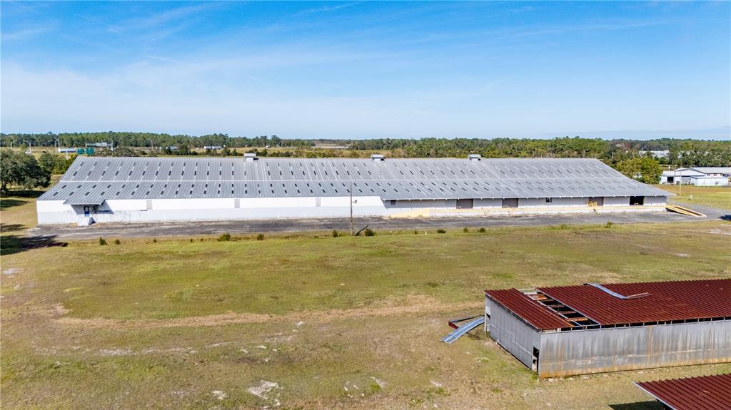 An aerial view shows a large, long industrial warehouse building with a metal roof — 14281 US HWY 301, STARKE, FL