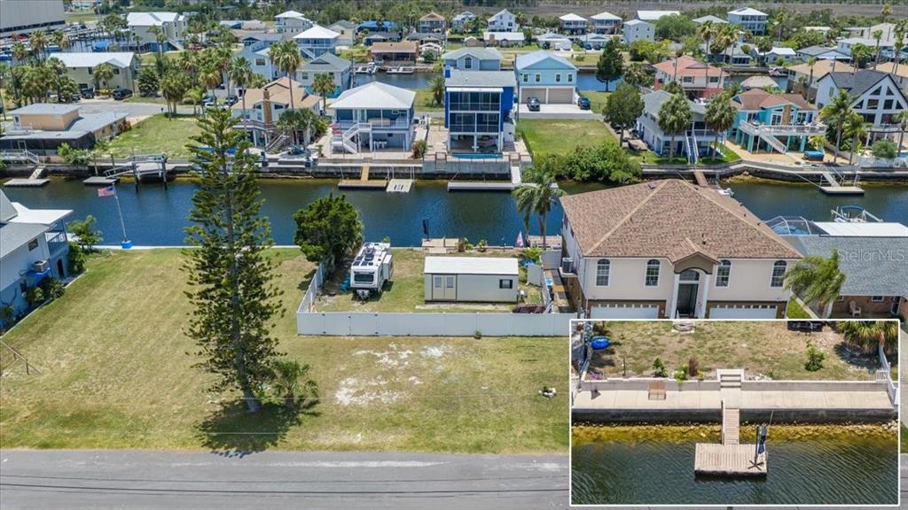 An aerial view shows a waterfront lot with a boat dock and a small shed — 4274 CARLOS COURT, HERNANDO BEACH, FL