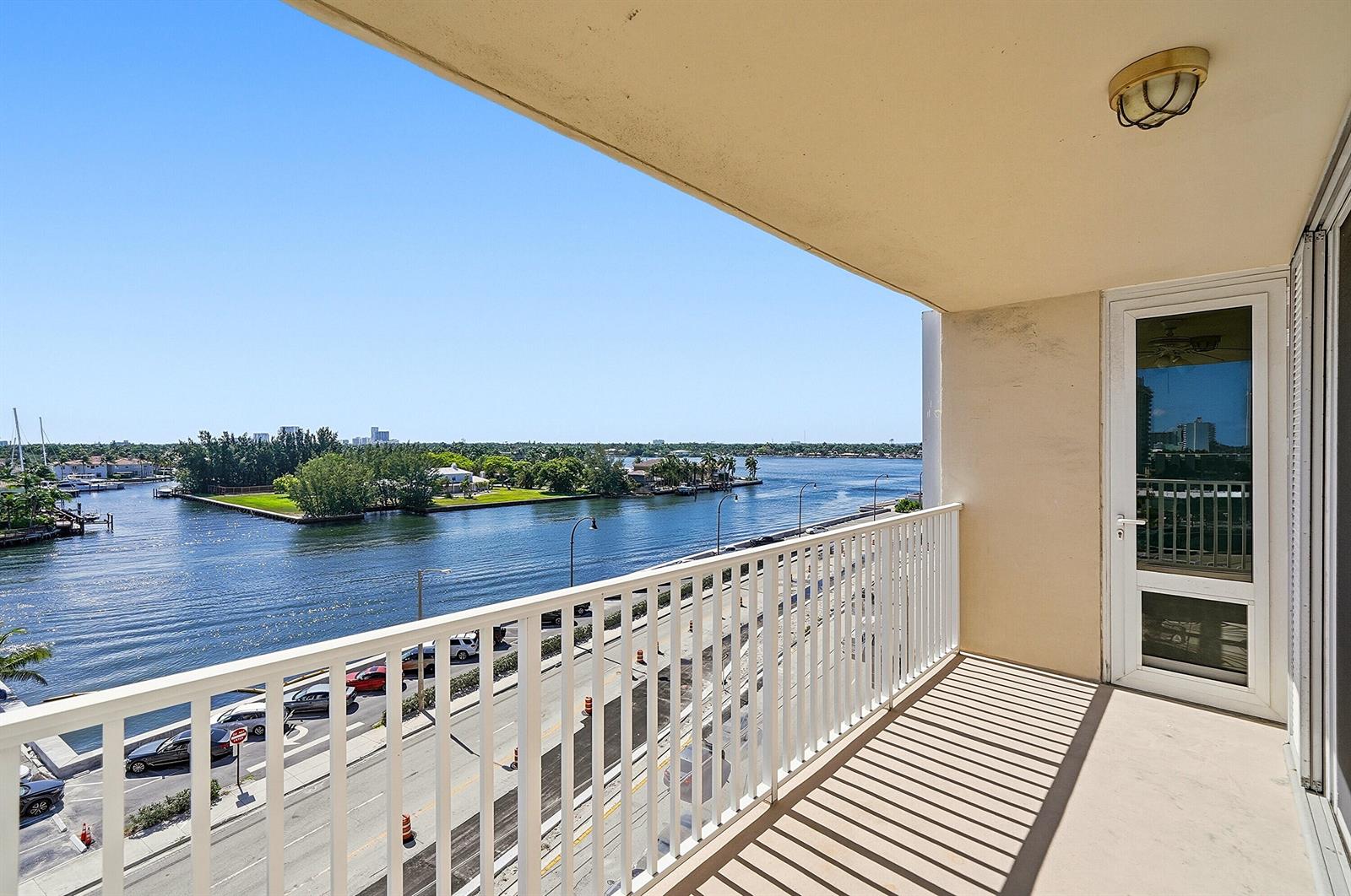 An elevated view of a coastal street with white apartment buildings and palm trees — 1401 S Ocean Drive # 704, Hollywood FL 33019, HOLLYWOOD, FL