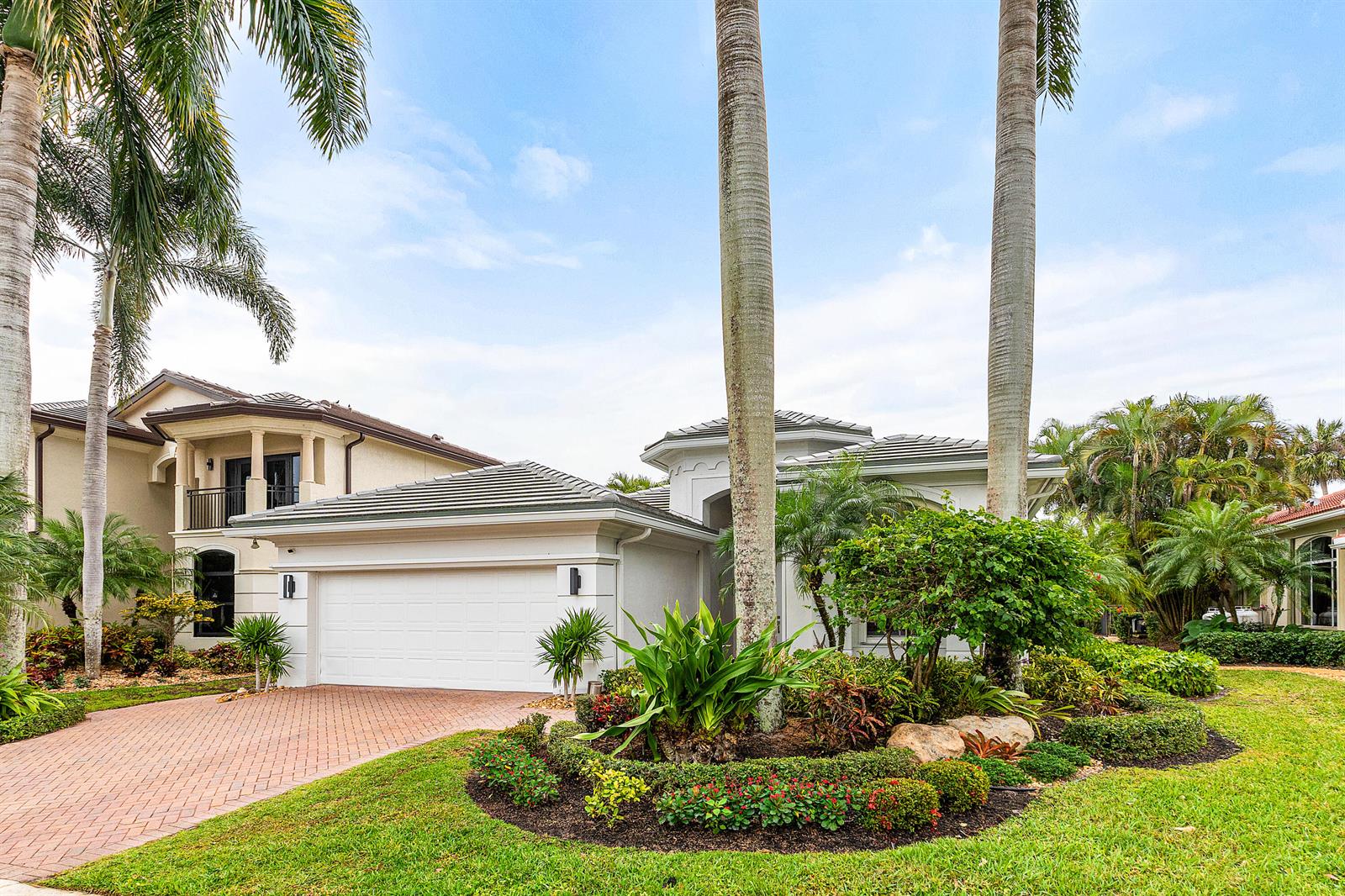 A white house with a two-car garage and palm trees in the front yard — 15856 Double Eagle Trail, Delray Beach FL 33446, DELRAY BEACH, FL