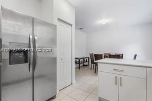 A stainless steel refrigerator stands next to a white door in a kitchen area — 2781 NW 55th Way, Lauderhill FL 33313, LAUDERHILL, FL