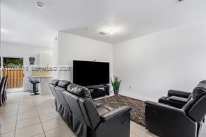 A living room features black leather recliners, a television, and tile flooring — 2781 NW 55th Way, Lauderhill FL 33313, LAUDERHILL, FL