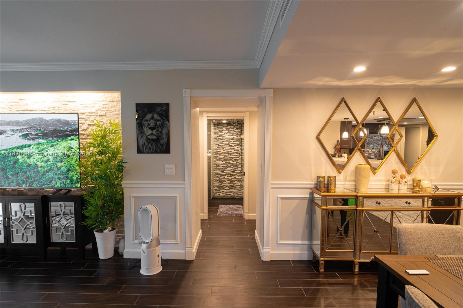 A living and dining area features dark wood floors, wainscoting, and a central hallway entrance — 6500 NW 2nd Ave # 114, Boca Raton FL 33487, BOCA RATON, FL