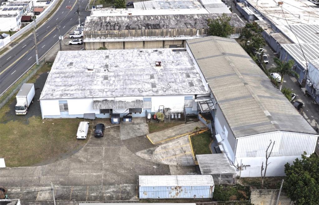 An aerial view shows a commercial warehouse building with a large parking lot and driveway — 20 ALBOLOTE AVE GUAYNABO IDUSTRIAL PARK, GUAYNABO, PR