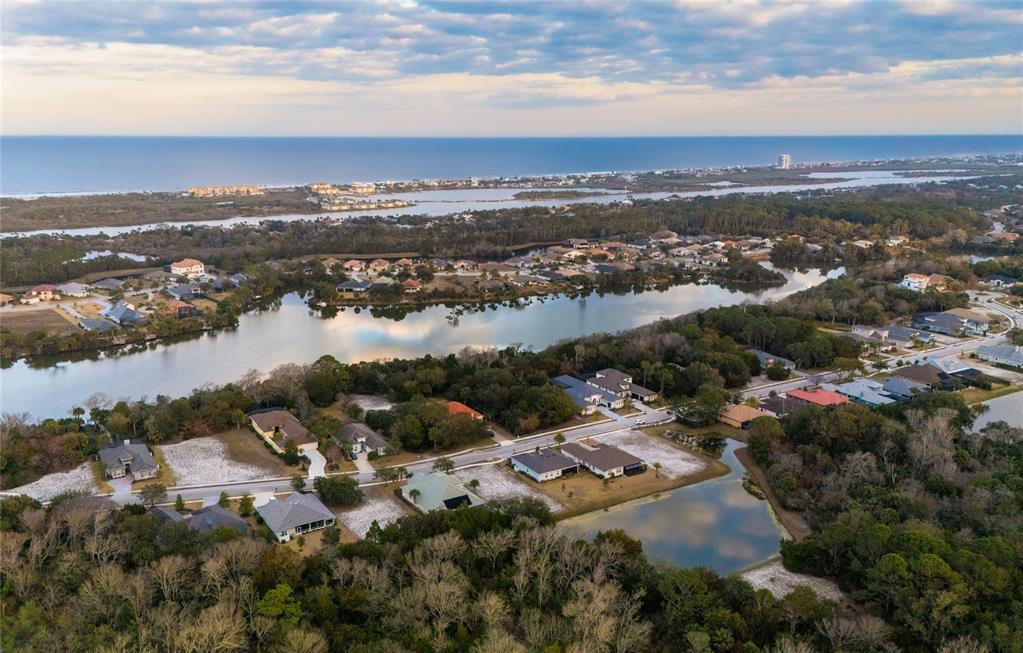 An aerial view of a swimming pool area with a clubhouse, gazebo, and lounge chairs — 43 N LAKEWALK DRIVE, PALM COAST, FL