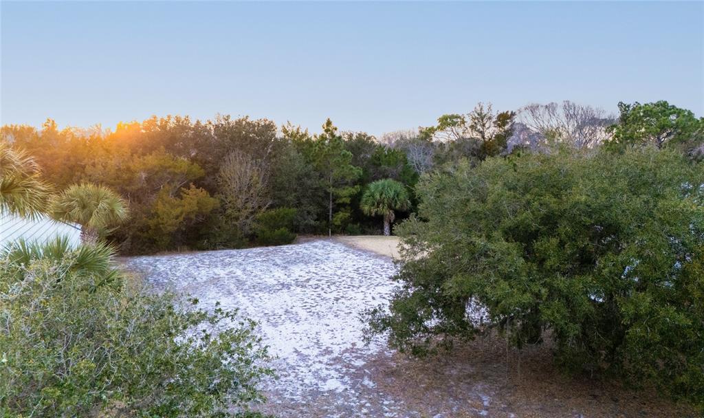 An aerial view shows a vacant residential lot marked with a pin between two houses — 43 N LAKEWALK DRIVE, PALM COAST, FL