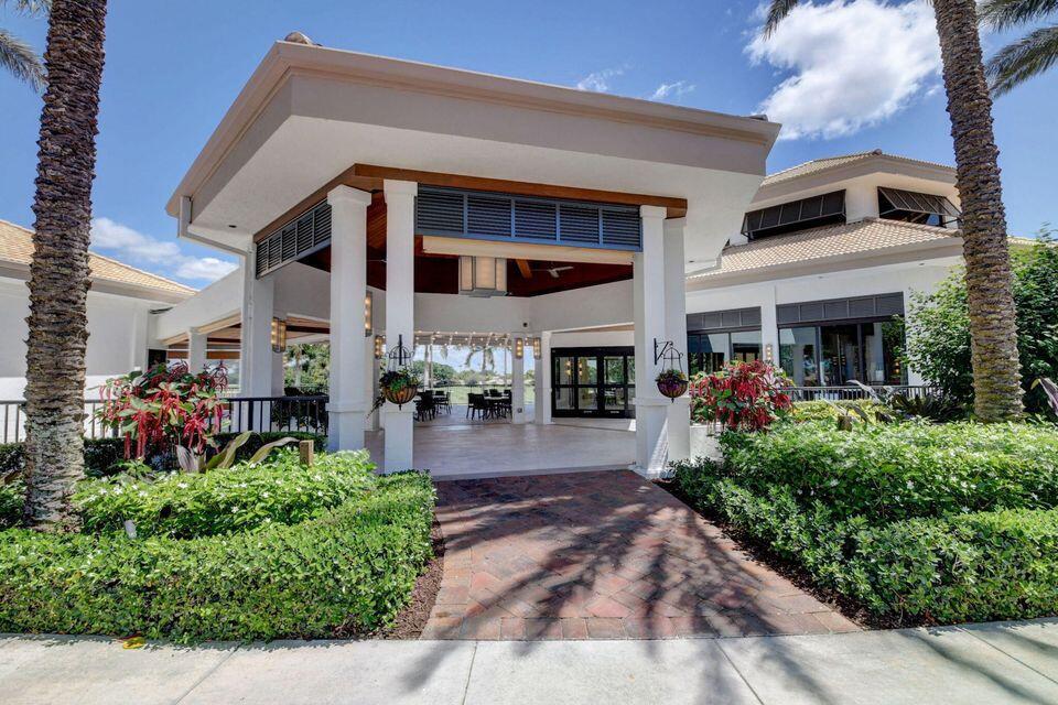 A covered outdoor patio area with white columns leads to a building entrance — 7344 Clunie Place # 13604, Delray Beach FL 33446, DELRAY BEACH, FL