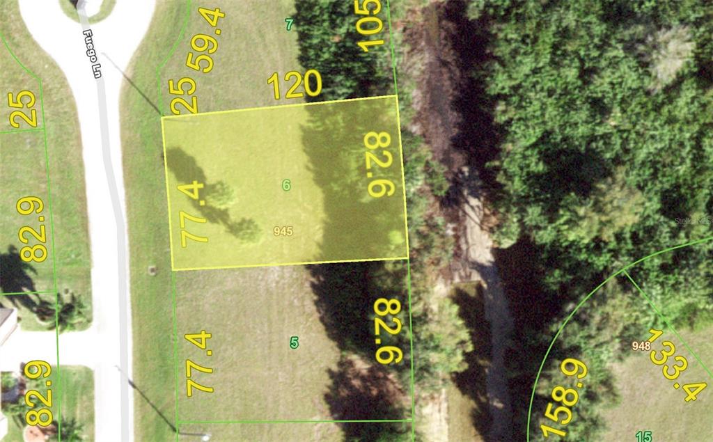 This is a satellite map showing a rectangular residential lot highlighted in yellow — 17424 FUEGO LANE, PUNTA GORDA, FL