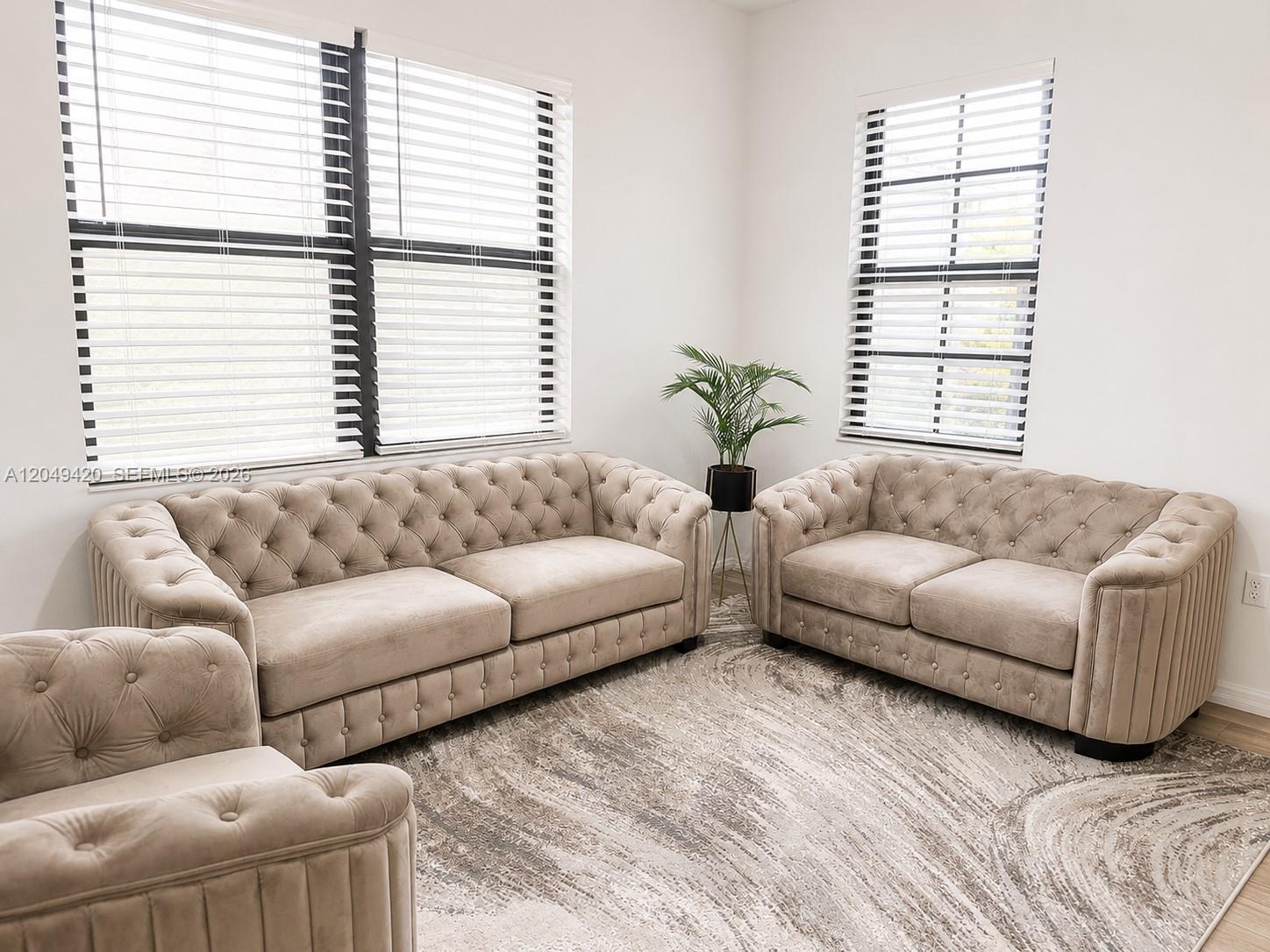 A living room features two tufted beige sofas, a patterned area rug, and two windows — 19316 NE 8th Ct, Miami FL 33179, MIAMI, FL