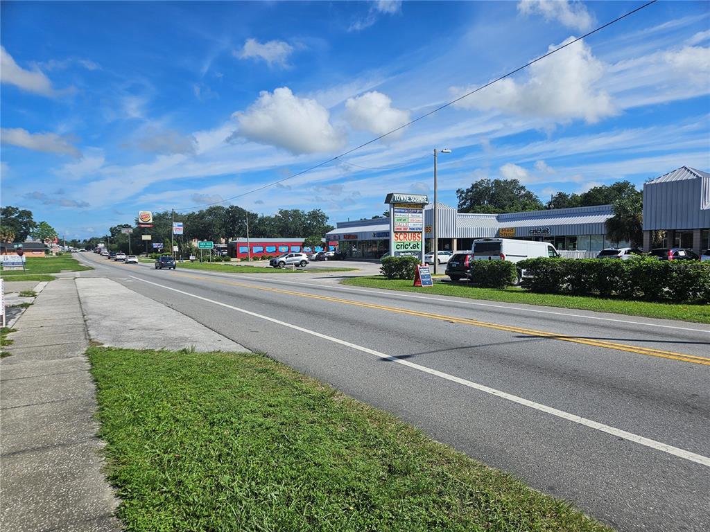 A view of a commercial strip mall with a parking lot along a road — 0 GALL BOULEVARD, ZEPHYRHILLS, FL