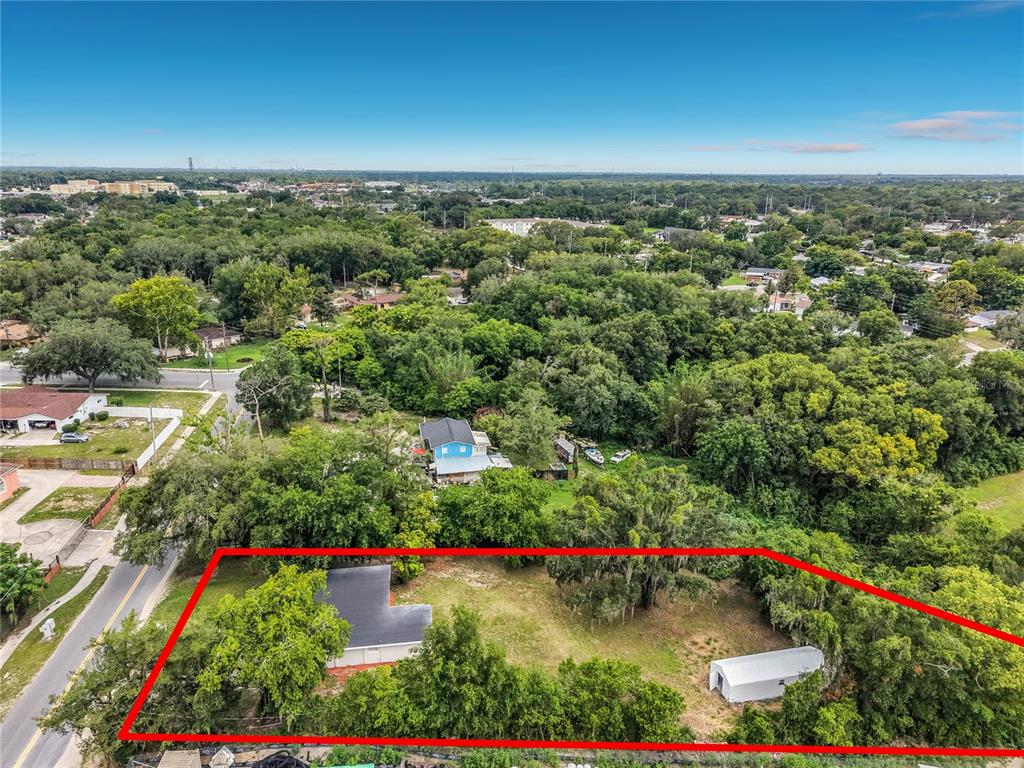 An aerial view shows a residential lot with a house and a detached carport — 3828 WHITE HERON DRIVE, ORLANDO, FL