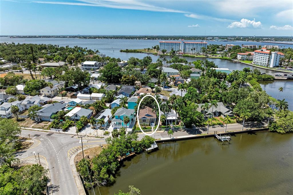 An aerial view shows a residential neighborhood with a circled house near a waterfront — 632 VIRGINIA DRIVE, BRADENTON, FL