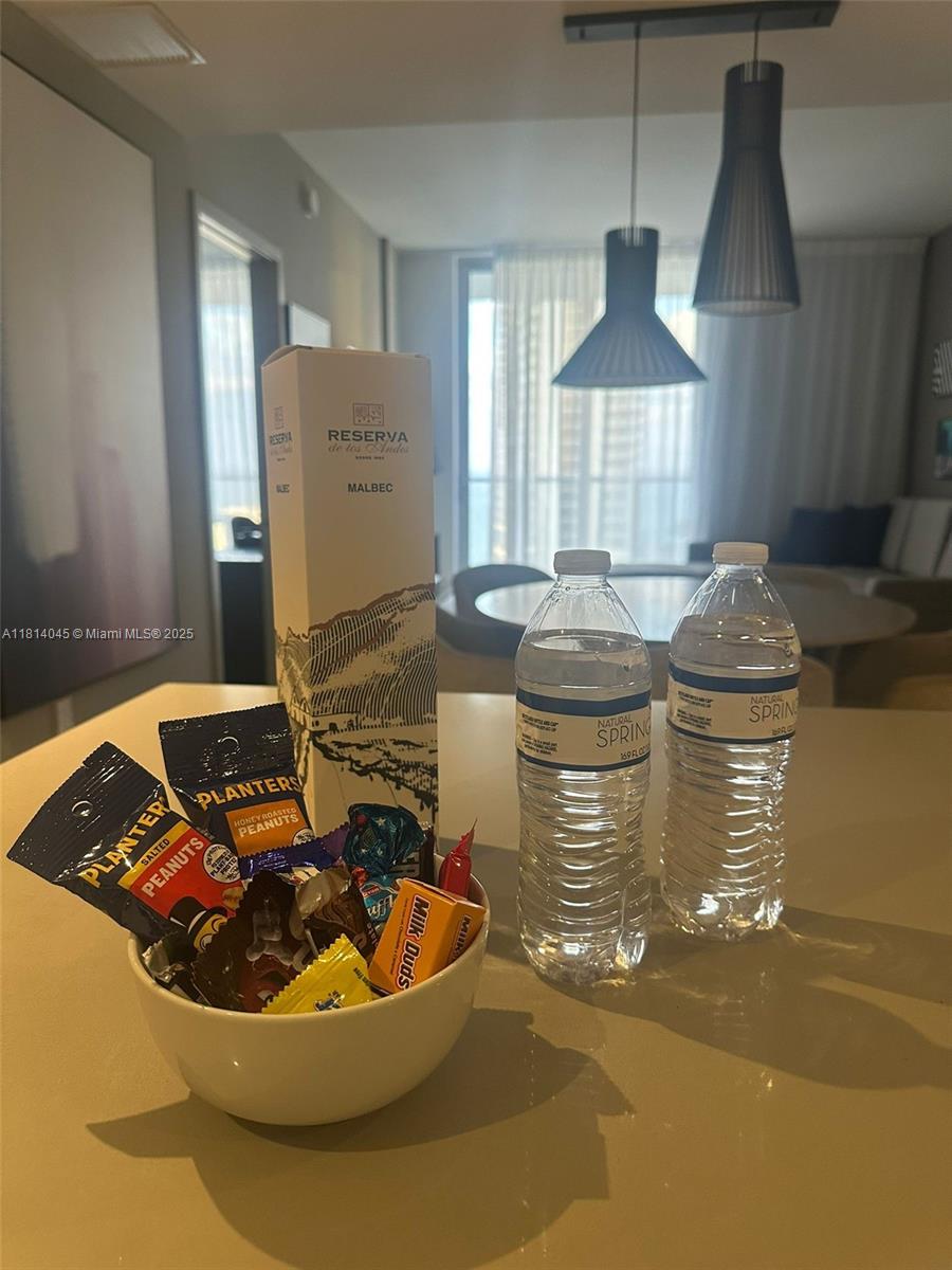 A kitchen counter holds a bowl of snacks, two water bottles, and a wine box — 4010 S Ocean Dr # R1507, Hollywood FL 33019, HOLLYWOOD, FL