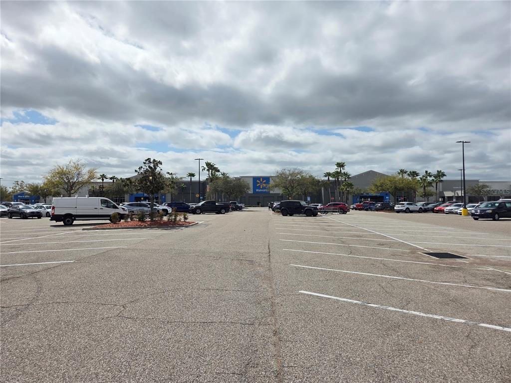 A large parking lot sits in front of a Walmart store under a cloudy sky — 9236-9248,9234 OLD GIBSONTON DRIVE, GIBSONTON, FL