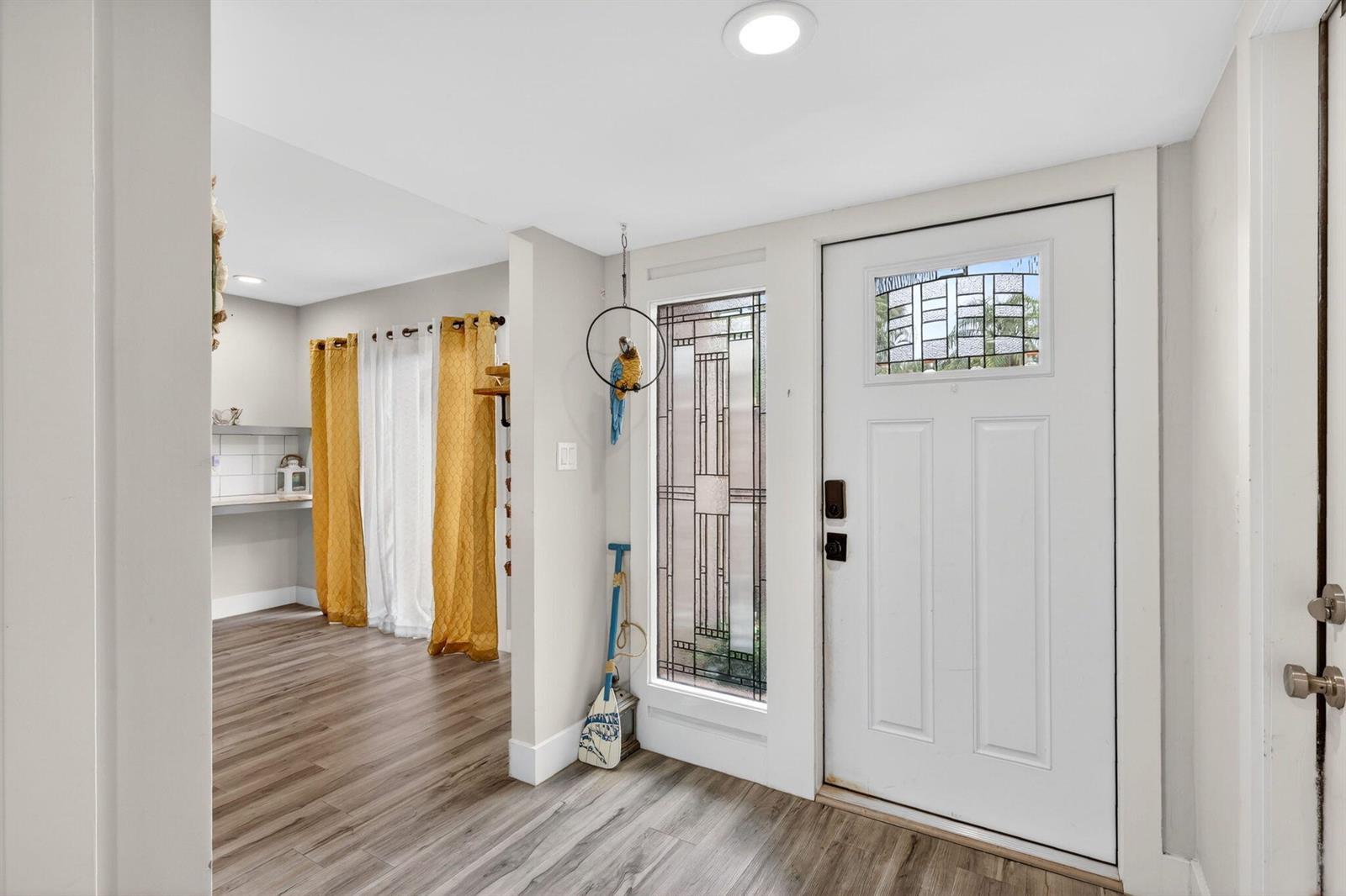 An entryway features a white front door with a stained glass window and wood-look flooring — 5316 Stonybrook Lane, Boynton Beach FL 33437, BOYNTON BEACH, FL
