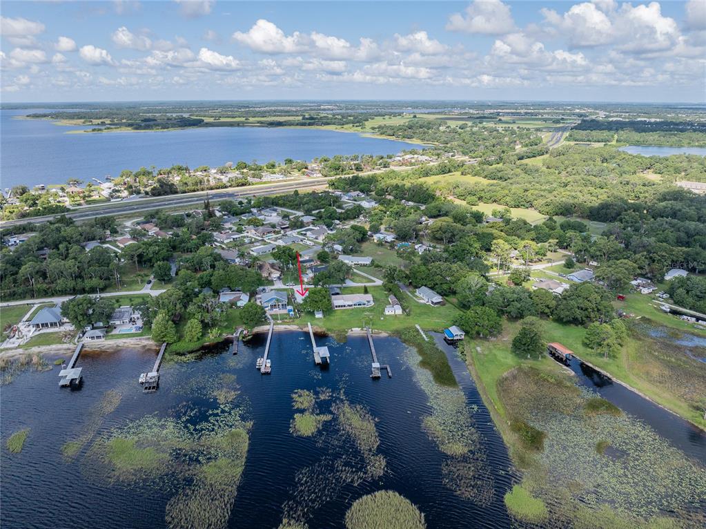 An aerial view shows a waterfront house with a private dock on a large lake — 6125 LAKE LIZZIE DRIVE, ST CLOUD, FL