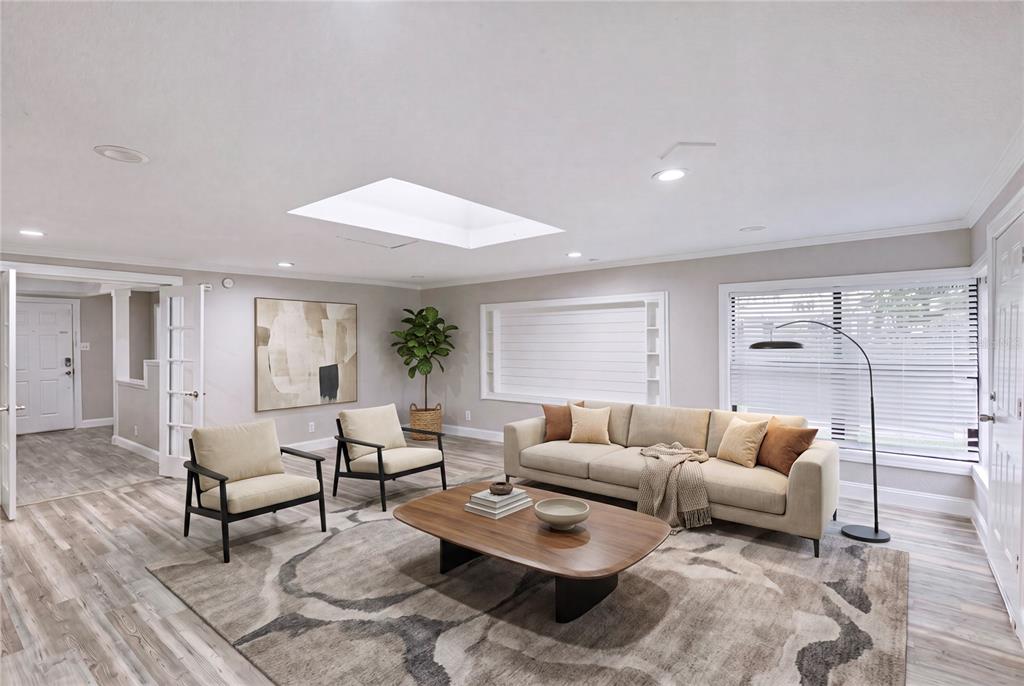 A living room features a beige sofa, two armchairs, a coffee table, and a skylight — 1325 E LAURA STREET, PLANT CITY, FL