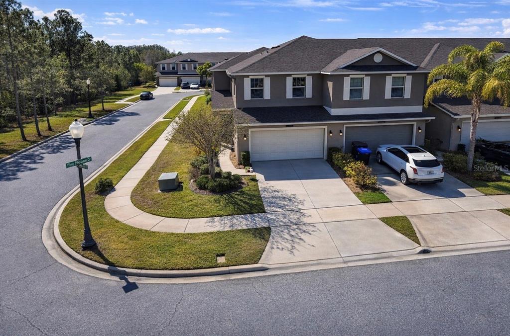 An aerial view of a two-story townhouse with a two-car garage and driveway — 15246 HARRINGTON COVE DRIVE, ORLANDO, FL