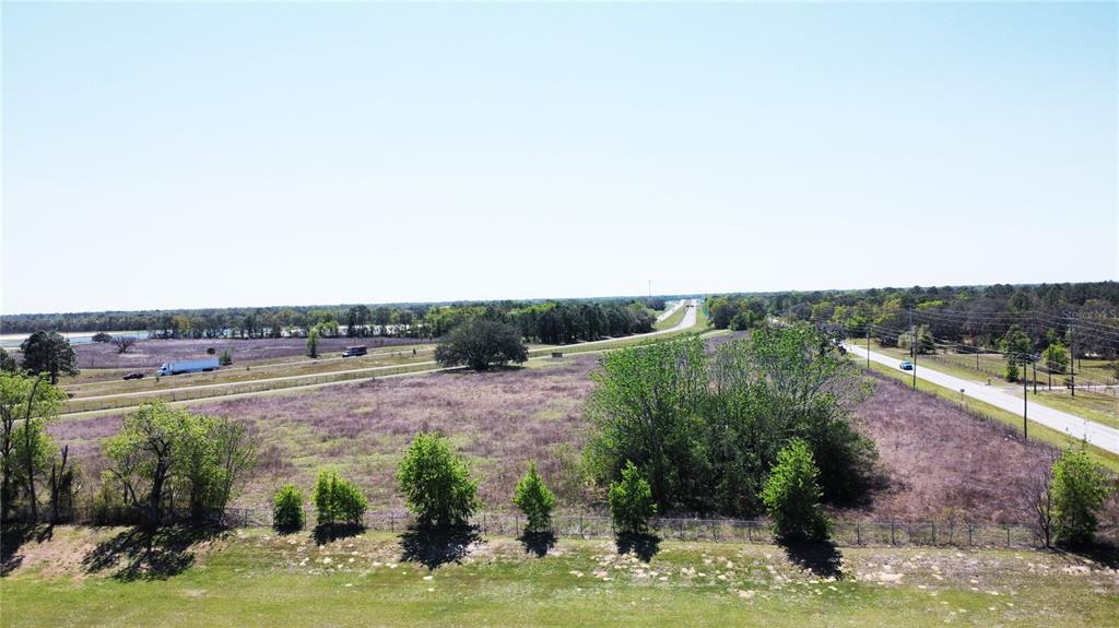 An aerial view of a large, flat, grassy vacant lot bordering a highway and road — 1290 ANDERSON SNOW ROAD, SPRING HILL, FL