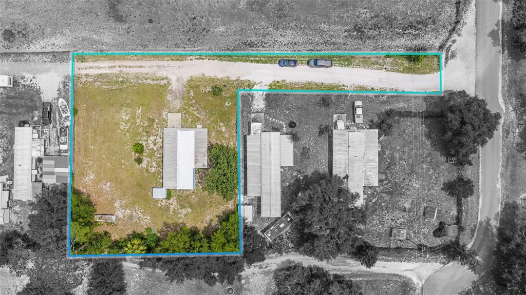 An aerial view shows a residential lot with a mobile home and trees outlined in blue — 1389 NW 7TH LANE, LAKE PANASOFFKEE, FL