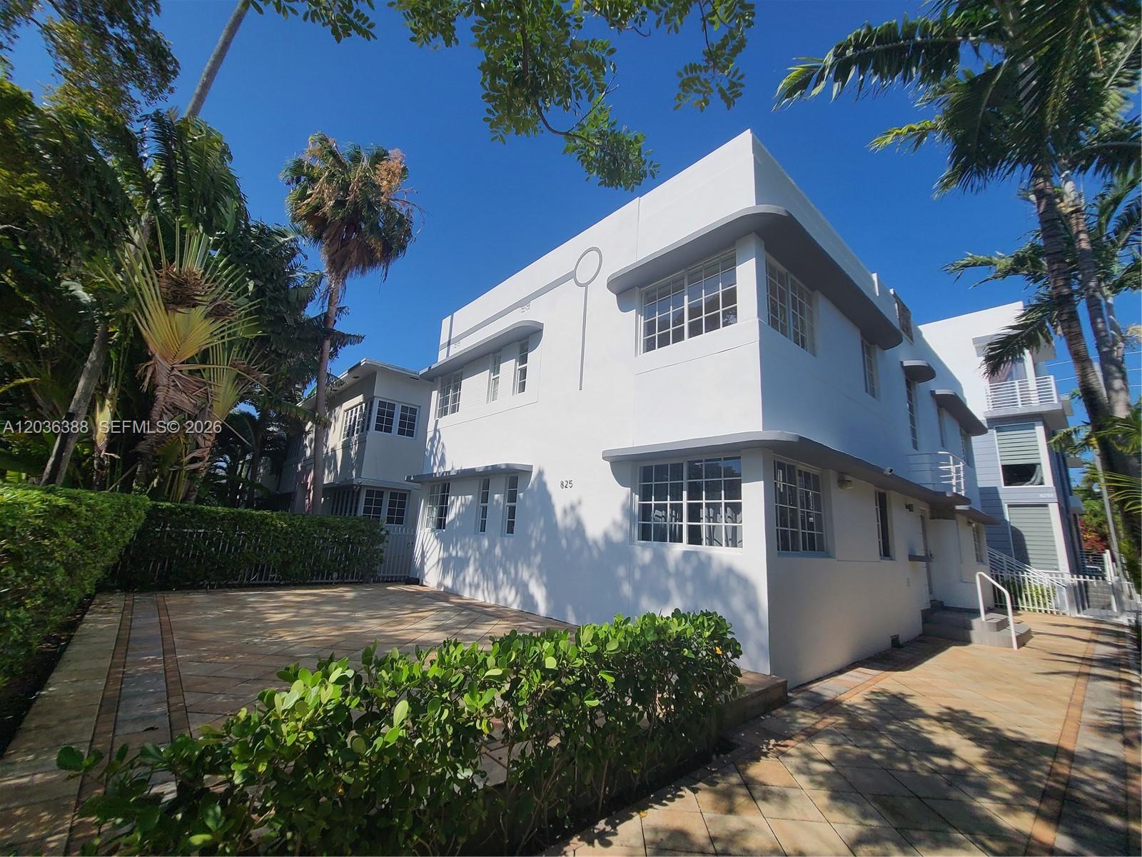 A two-story white Art Deco building features rounded corners and multi-pane windows under a blue sky — 825 Michigan Ave # 3, Miami Beach FL 33139, MIAMI BEACH, FL