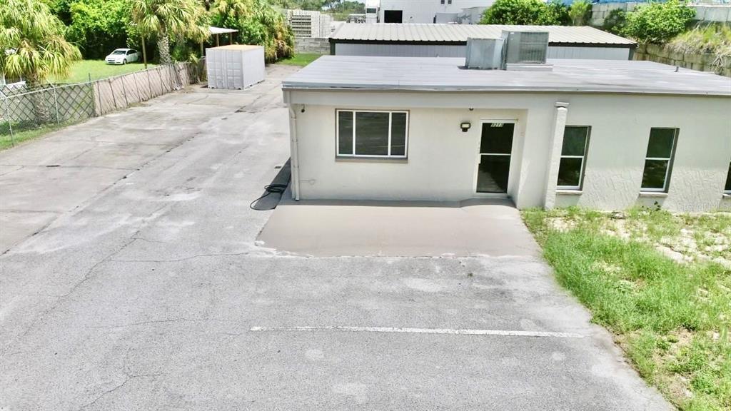An exterior view of a single-story commercial building with a paved parking lot — 9213 DENTON AVENUE, HUDSON, FL