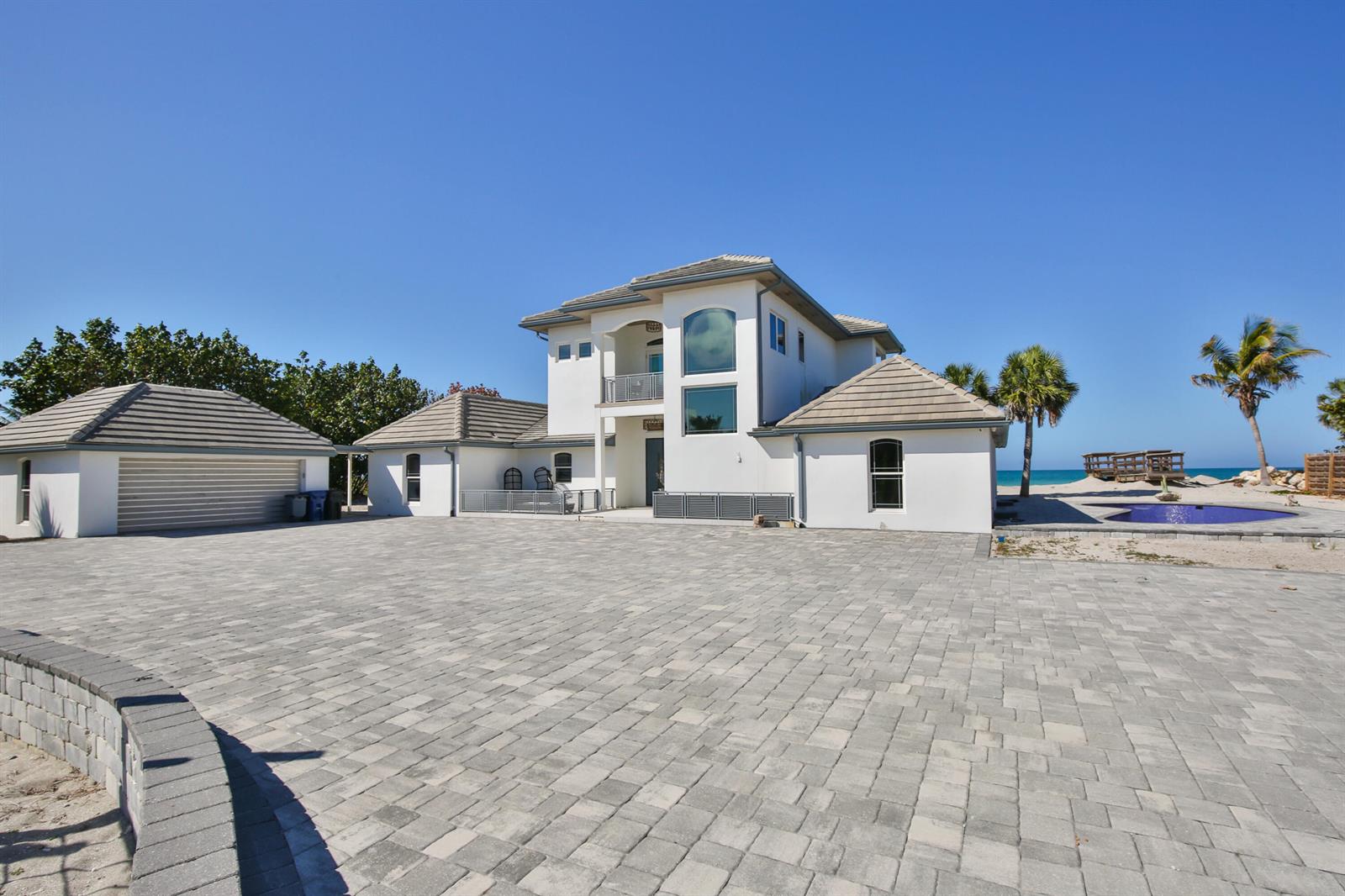 A large white house with a paved driveway and a pool near the ocean — 7816 Sanderling Road, Sarasota FL 34242, SARASOTA, FL