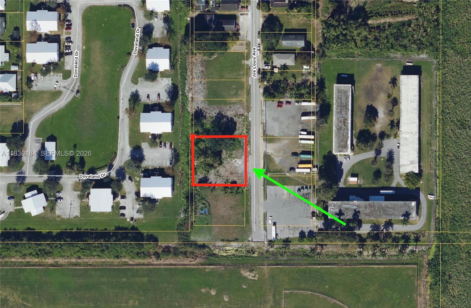 This is an aerial map showing a vacant lot highlighted in red along a road — 875 JOE LOUIS AVE, Pahokee FL 33476, PAHOKEE, FL